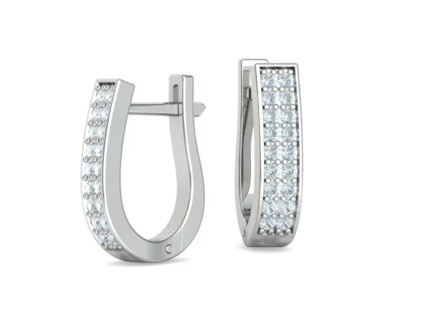 Close-up of Huggie Diamond Earrings showcasing their brilliant diamonds in a secure, comfortable fit around the earlobe, displayed on a sleek white surface