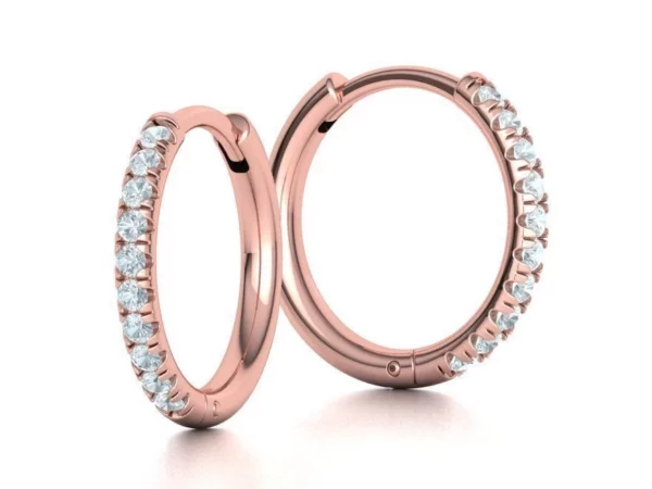 Small hoop earrings featuring a sparkling French pave setting with closely set gems, showcasing a seamless and elegant design on a hypoallergenic metal