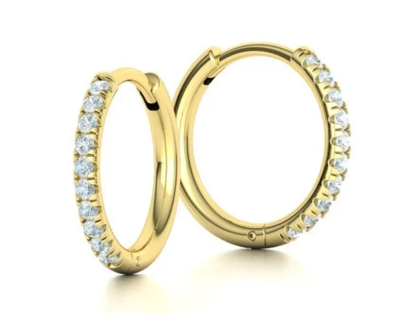 Chic and sophisticated small hoop earrings, displaying a radiant French pave setting with numerous tiny, glittering stones, perfect for both casual and formal wear.