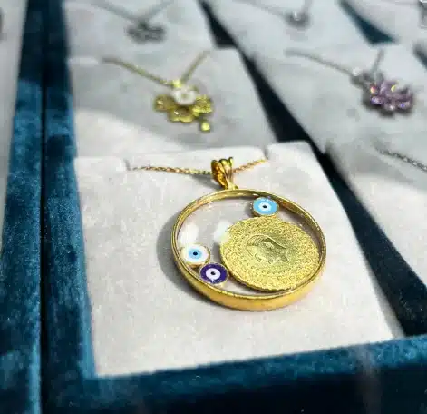 Close-up of a variety of traditional Turkish jewelry pieces featuring the evil eye motif, geometric patterns, and floral designs in gold and silver.