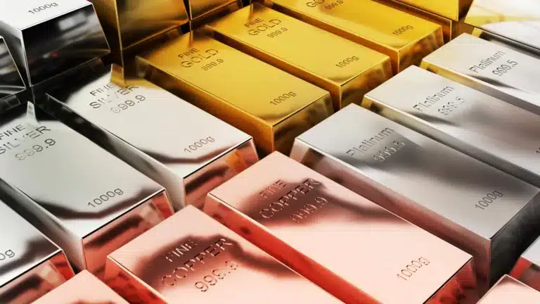 Graphs and charts illustrating the fluctuating prices of precious metals on a digital tablet, with jewelry pieces visible in the background.